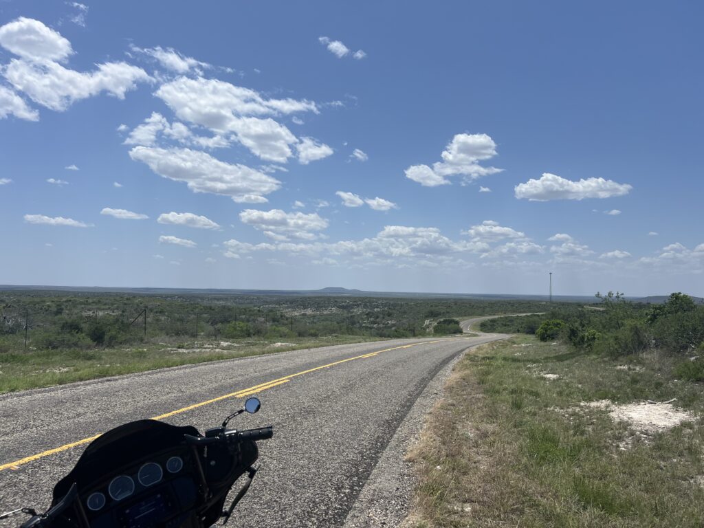 An open road portion of Ranch Road 674 overlooking the landscape.